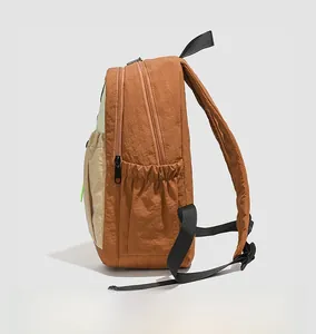 Detail view of the durable nylon fabric and drawstring side pocket on the contrast backpack