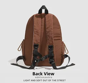 Detailed back view of a brown nylon backpack showing padded straps and adjustable buckles