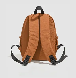 Detail view of water-resistant nylon backpack back with wide shoulder straps and side pocket