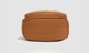 Detail view of the durable backpack bottom featuring contrast color stitching and nylon texture