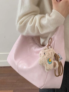 Pink PU leather half-moon hobo bag with cute sheep charm shown on a female model