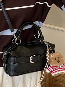 Vintage black leather pillow bag with brown bear keychain and silver metal hardware accents