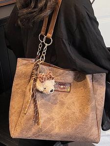 Brown large capacity tote bag with bear pattern embossing and chain strap detail