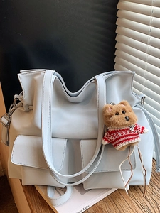Light blue PU leather tote bag with brown plush bear charm and dual flap pockets