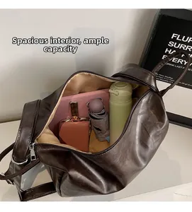 Spacious interior of a dark brown PU leather tote bag holding a tablet and umbrella