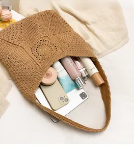 Top-down view of a crochet beach bag showing a spacious interior for a tablet and cosmetics