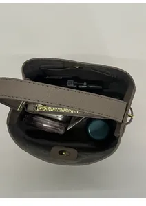 Top view of taupe bucket bag showing spacious interior with magnetic closure and zipper pocket