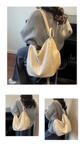 Detail view of large cream-white pleated tote bag with functional side zipper pocket