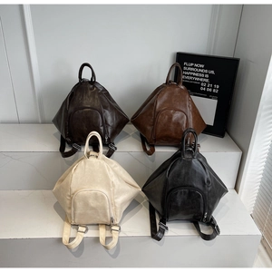 Detailed display of vintage-style textured leather backpacks in four classic colors