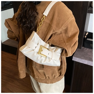 Close-up of soft pleated cloud bag in off-white PU leather with gold buckle detail