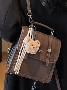 Brown contrast leather backpack with teddy bear charm and striped ribbon for women