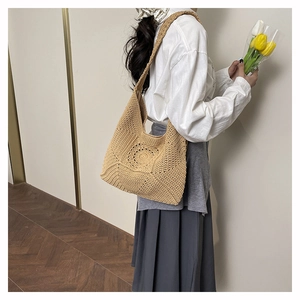 Detailed texture of hand-woven hollow flower shoulder bag in natural beige color