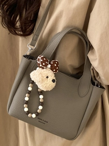 Chic grey litchi pattern leather handbag with plush puppy charm and detachable strap
