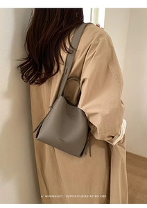 Detail of lychee pattern leather bucket bag showing fine texture and stitching