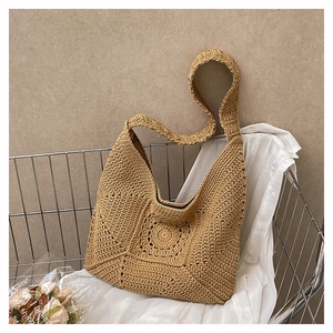 Detailed texture of cotton weave and floral knit pattern on a large beach tote bag