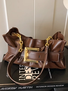 Vintage dark brown pleated leather shoulder bag with bold gold buckle and chain strap