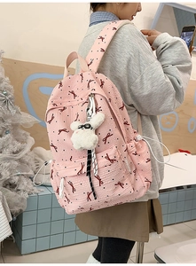 Pink casual backpack with red bow prints and a cute plush bunny charm detail
