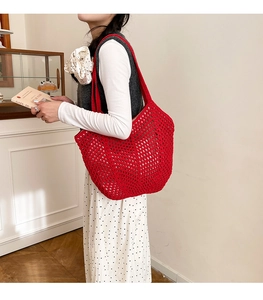 Detail of red crochet tote bag showing hollow-out mesh texture and woven pattern