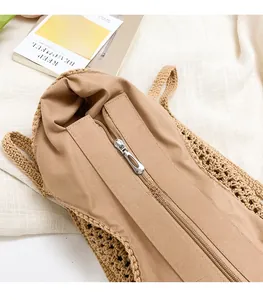 Detail shot of the woven tote bag featuring a smooth silver zipper closure and lining