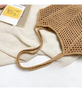 Detailed macro view of khaki hand-knitted tote bag with intricate hollow mesh texture