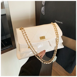Detail of off-white quilted chain bag with high-gloss finish and golden clasp lock