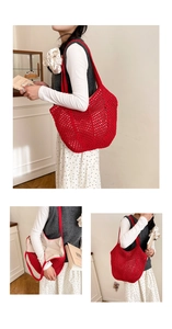 Detail view of red crochet tote bag featuring mesh texture and secure zipper lining