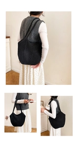Detail view of black crochet tote bag featuring handcrafted hollow knit texture and design