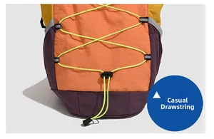 Detail of outdoor backpack featuring colorful patchwork and yellow elastic drawstring system