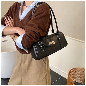 Detailed view of the large capacity black PU leather shoulder bag on model shoulder