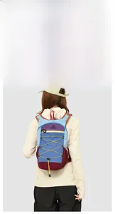Close-up of functional hiking backpack with colorful panels and yellow bungee cords