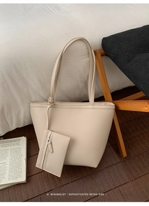 Close-up of off-white lychee texture tote bag with matching small zippered coin purse