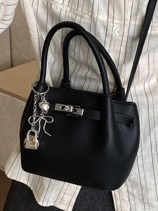 Classic black pebbled leather bucket bag with silver lock and metallic heart charm