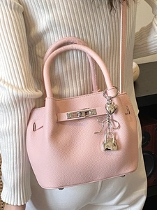 Pink lychee texture leather bucket bag with silver heart and bow charms