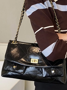 Black quilted oil wax leather tote bag with gold chain strap and square turn lock
