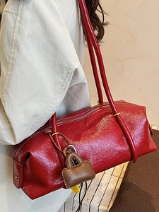 Retro red Boston bag in glossy leather with brown lock charm and long shoulder straps