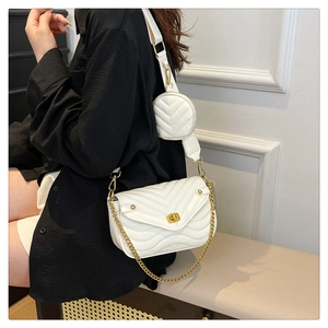 Chic white quilted crossbody bag detail with golden lock and round coin purse