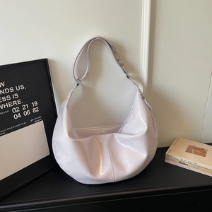 Detail view of glossy lilac hobo bag with smooth finish and high-quality wide shoulder strap
