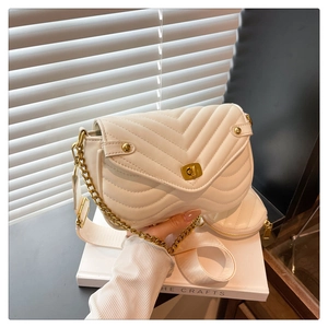 Detail of beige quilted flap bag with gold chain strap and mini round coin purse