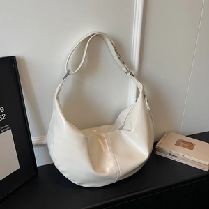 Detail of off-white hobo bag with glossy finish and silver chain strap connector