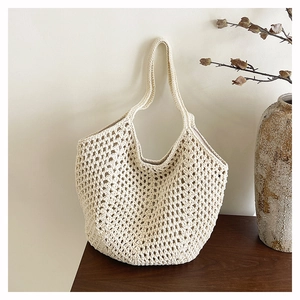 Close-up of crochet knit tote bag showing intricate hollow grid pattern and inner lining