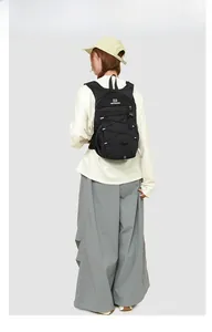 Detailed back view of a black outdoor sports backpack with elastic drawstring and brand logo