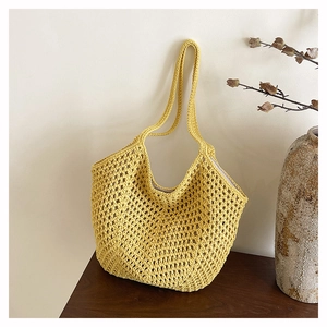 Detailed close-up of yellow crochet tote bag showing hollow-out woven texture and patterns