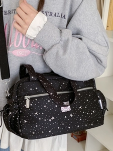 Black star print shoulder bag with adjustable strap and side pockets for casual daily use