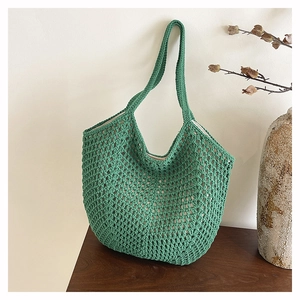 Detailed close-up of grass green woven mesh tote bag showing intricate crochet texture