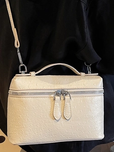 Chic cream ostrich-textured handbag with top handle and adjustable silver strap for women