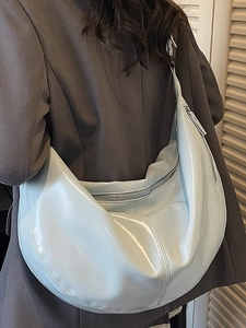 Pale blue crescent hobo bag in glossy leather finish for casual commuting wear
