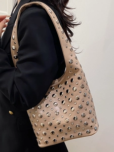 Beige faux leather underarm bag featuring trendy silver rivet studs for a chic style