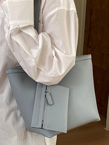 Light blue pebbled leather tote bag set with matching pouch and white contrast stitching