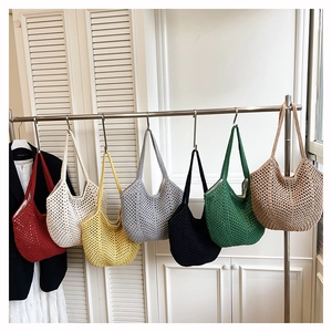 Detail view of colorful crochet tote bags in a minimalist mesh knit with diverse colors