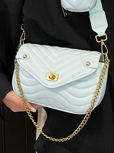 Quilted mint blue crossbody bag with gold chain and matching small pendant pouch